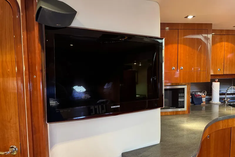  Yacht Photos Pics Interior of 2010 Regal 44 Sport Coupe with TV, wooden cabinets, and modern kitchen amenities.