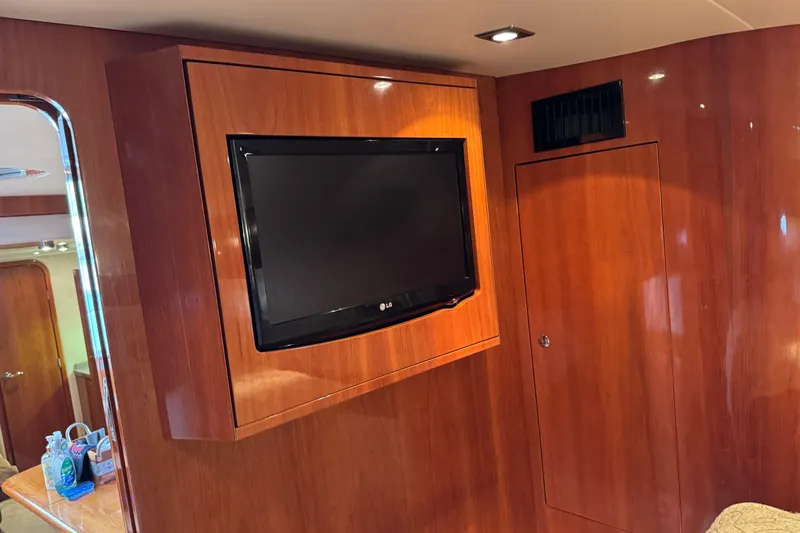  Yacht Photos Pics Interior of 2010 Regal 44 Sport Coupe with mounted TV and wooden paneling.