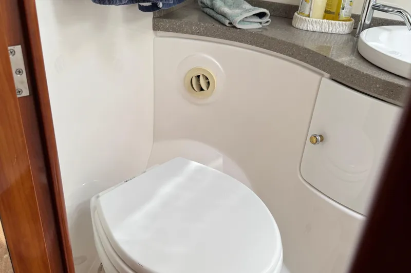  Yacht Photos Pics Bathroom interior of 2010 Regal 44 Sport Coupe yacht, featuring a compact toilet and countertop.