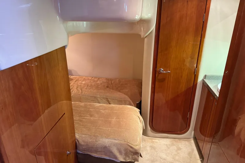  Yacht Photos Pics Interior cabin of 2010 Regal 44 Sport Coupe with twin beds and wooden finishes.