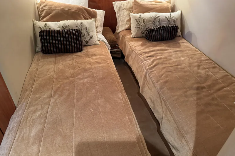  Yacht Photos Pics Interior of 2010 Regal 44 Sport Coupe with twin beds and decorative pillows.