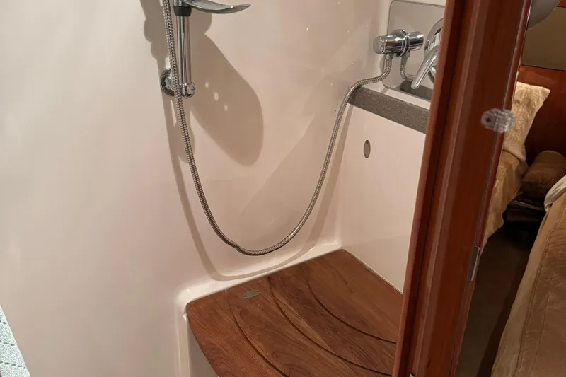  Yacht Photos Pics Shower area in 2010 Regal 44 Sport Coupe yacht with wooden seat and chrome fixtures.
