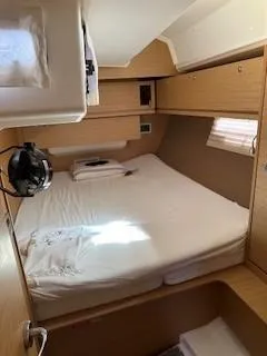 Yacht Photos Pics Cozy cabin interior of 2018 Dufour 512 Grand Large yacht with wooden finish.