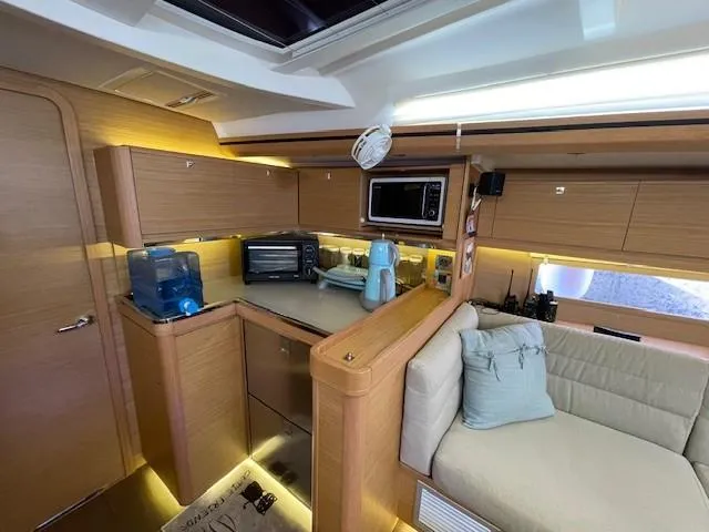  Yacht Photos Pics Interior of 2018 Dufour 512 Grand Large yacht with modern kitchen and cozy seating area.