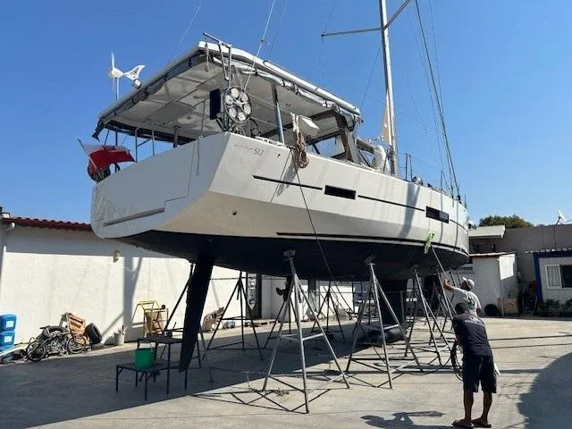  Yacht Photos Pics 2018 Dufour 512 Grand Large sailboat on stands in a boatyard, undergoing maintenance.