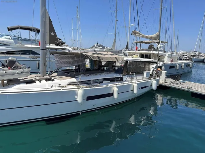  Yacht Photos Pics 2018 Dufour 512 Grand Large yacht docked in a marina, surrounded by other boats.