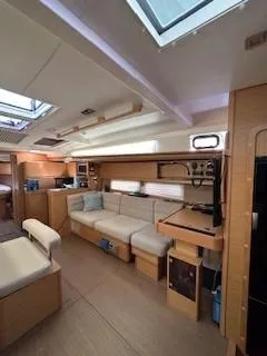  Yacht Photos Pics Interior of 2018 Dufour 512 Grand Large yacht, featuring modern seating and natural light.
