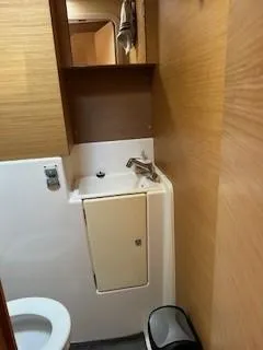 Yacht Photos Pics Bathroom interior of 2018 Dufour 512 Grand Large yacht, featuring sink and toilet.