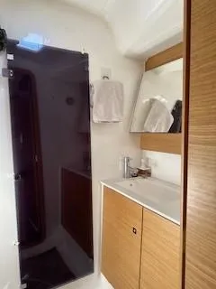  Yacht Photos Pics Bathroom interior of 2018 Dufour 512 Grand Large yacht with wooden cabinetry.