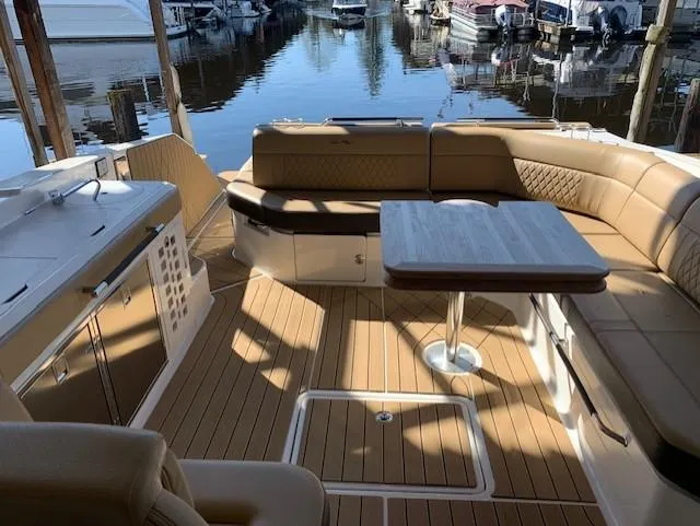  Yacht Photos Pics 2022 Sea Ray SLX 400 boat interior with seating and table, docked at marina.