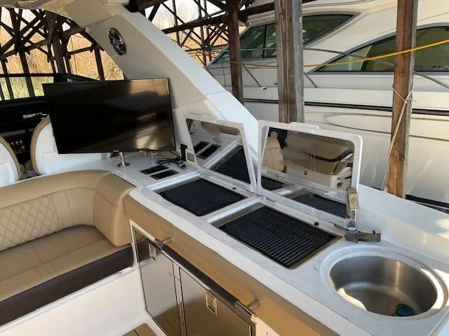  Yacht Photos Pics Luxurious 2022 Sea Ray SLX 400 yacht interior with kitchenette and seating area.