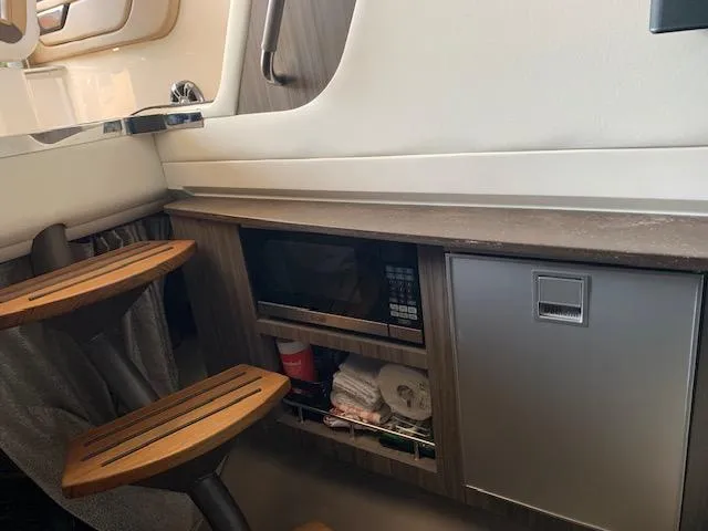  Yacht Photos Pics Interior of 2022 Sea Ray SLX 400 with wooden steps, microwave, and storage.