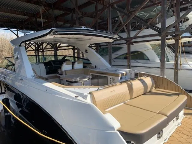  Yacht Photos Pics 2022 Sea Ray SLX 400 luxury boat with spacious seating, docked under a covered marina.