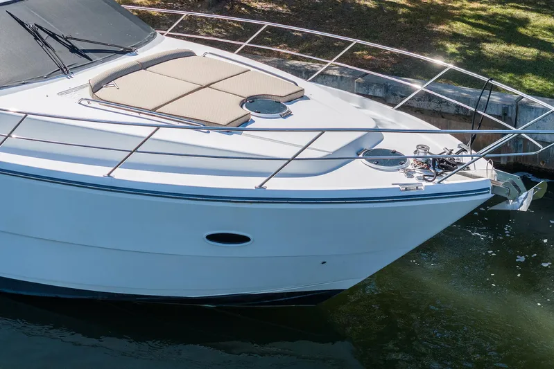 Carrie Ann Yacht Photos Pics 2006 Neptunus 62 Flybridge yacht with sunpad, docked in calm waters.