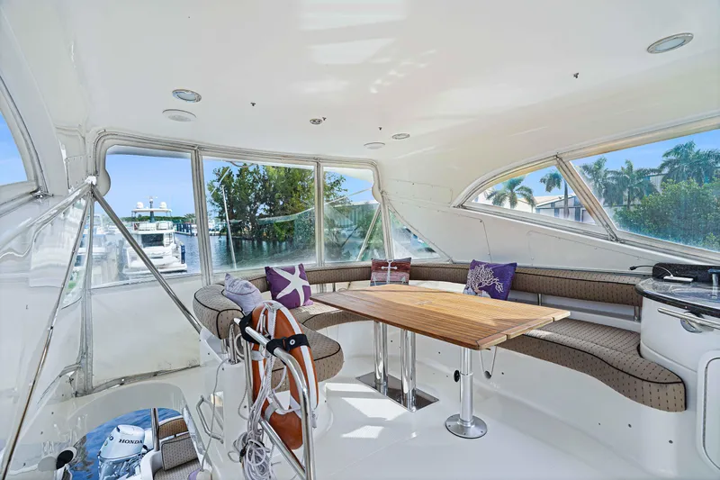 Carrie Ann Yacht Photos Pics Luxurious 2006 Neptunus 62 Flybridge yacht interior with spacious seating and scenic marina view.