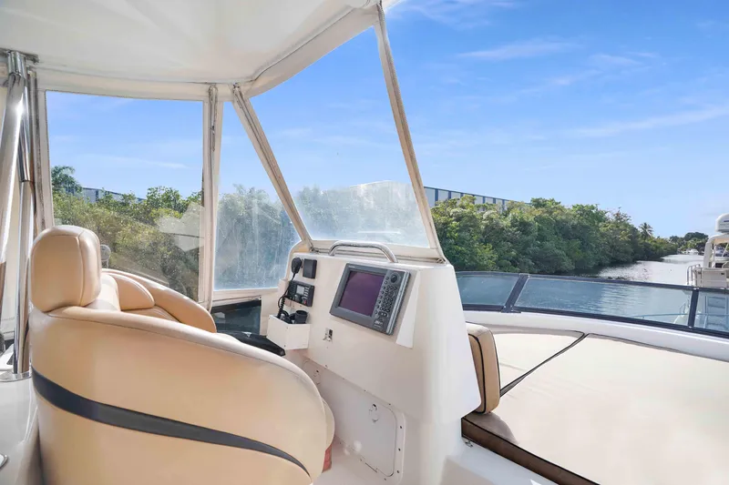 Carrie Ann Yacht Photos Pics Flybridge view of 2006 Neptunus 62 yacht, featuring helm and waterway scenery.