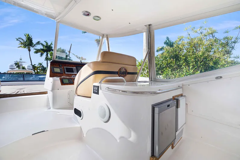 Carrie Ann Yacht Photos Pics 2006 Neptunus 62 Flybridge interior with helm and seating, surrounded by tropical scenery.
