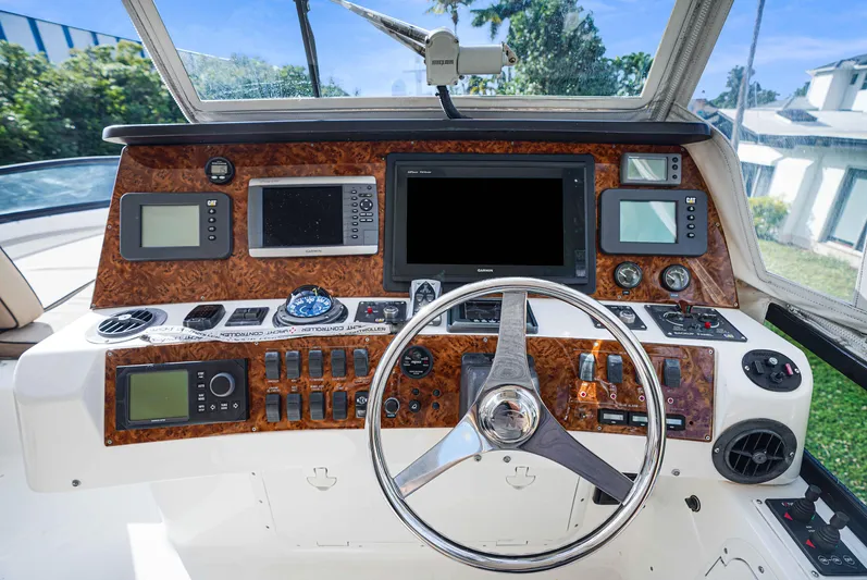 Carrie Ann Yacht Photos Pics Helm of 2006 Neptunus 62 Flybridge yacht with advanced navigation controls and steering wheel.
