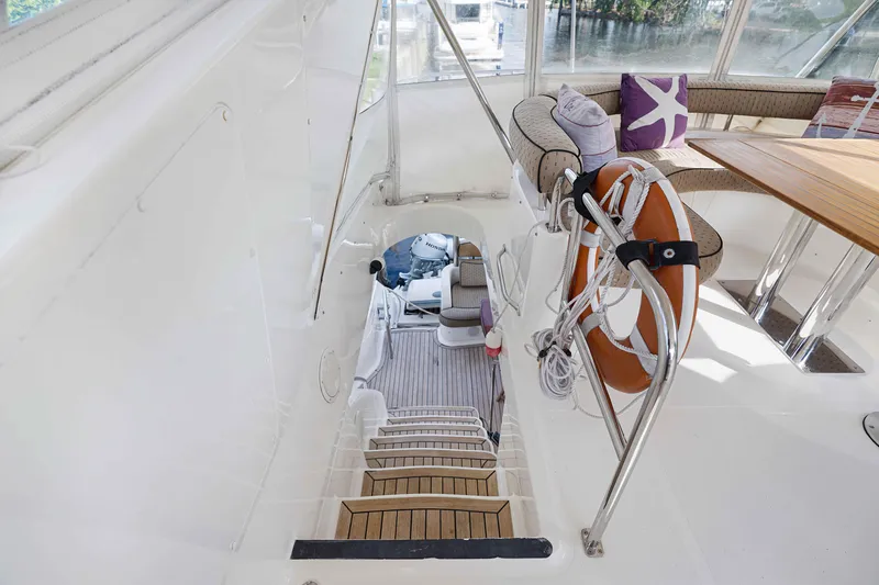 Carrie Ann Yacht Photos Pics Luxurious 2006 Neptunus 62 Flybridge yacht interior with elegant seating and safety equipment.