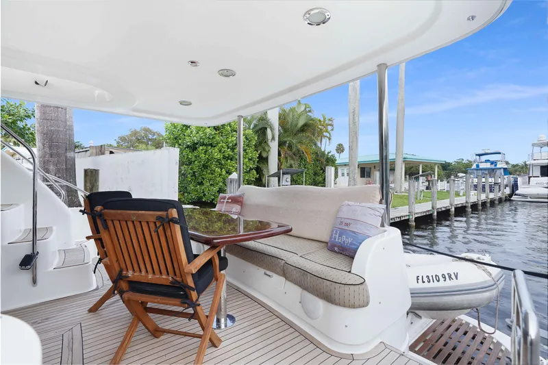 Carrie Ann Yacht Photos Pics Luxurious 2006 Neptunus 62 Flybridge yacht with elegant outdoor seating area.