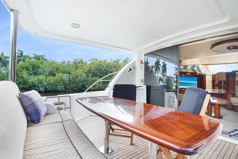 Carrie Ann Yacht Photos Pics Luxurious 2006 Neptunus 62 Flybridge yacht interior with elegant seating and polished wood table.