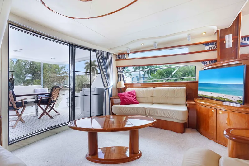 Carrie Ann Yacht Photos Pics Luxurious interior of 2006 Neptunus 62 Flybridge yacht with elegant seating and ocean view.