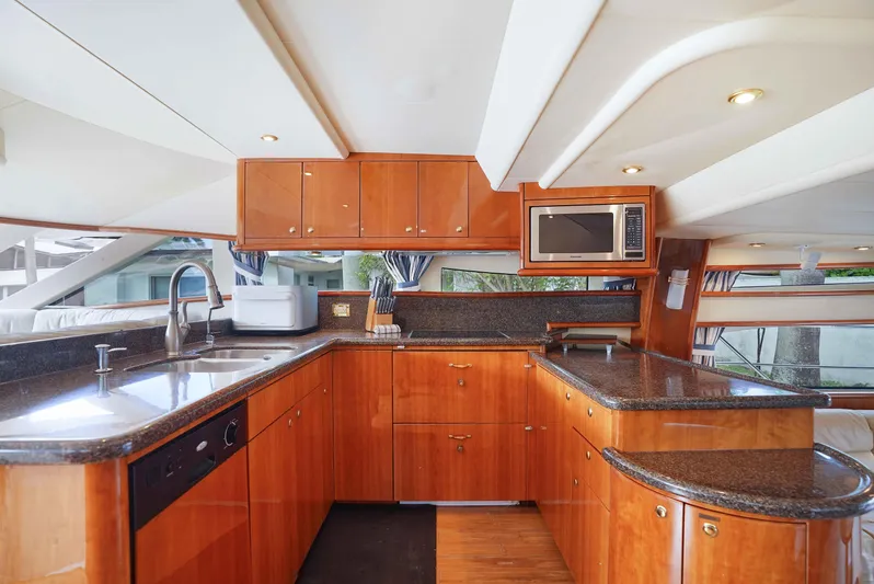 Carrie Ann Yacht Photos Pics Luxurious kitchen interior of 2006 Neptunus 62 Flybridge yacht with modern amenities.