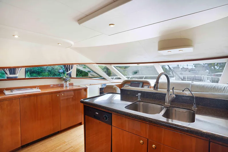 Carrie Ann Yacht Photos Pics Luxurious 2006 Neptunus 62 Flybridge yacht interior with modern kitchen and panoramic windows.