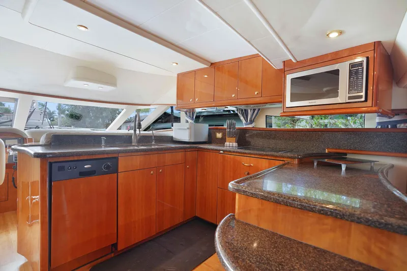 Carrie Ann Yacht Photos Pics Luxurious kitchen interior of 2006 Neptunus 62 Flybridge yacht with modern appliances.