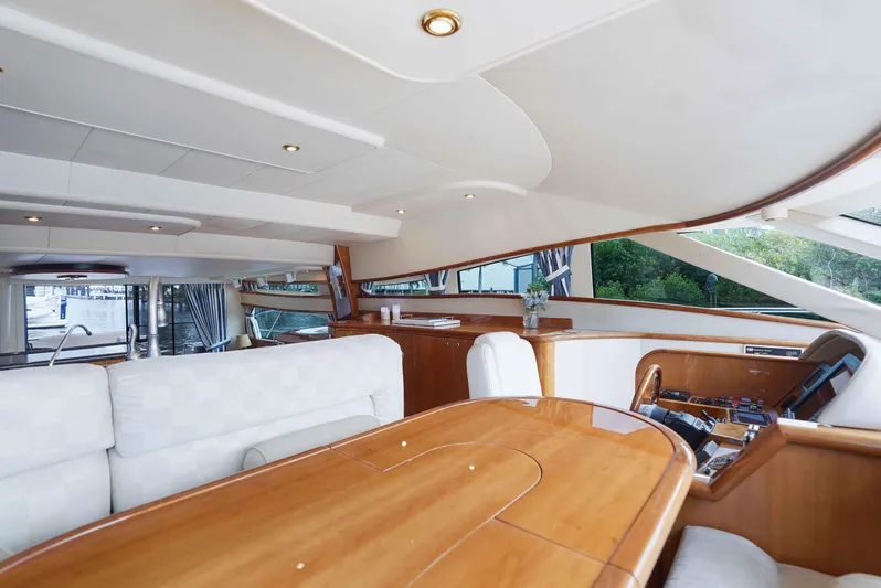 Carrie Ann Yacht Photos Pics Luxurious interior of 2006 Neptunus 62 Flybridge yacht with elegant wood finishes.