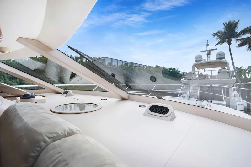 Carrie Ann Yacht Photos Pics Interior view of 2006 Neptunus 62 Flybridge yacht with clear sky and palm trees.