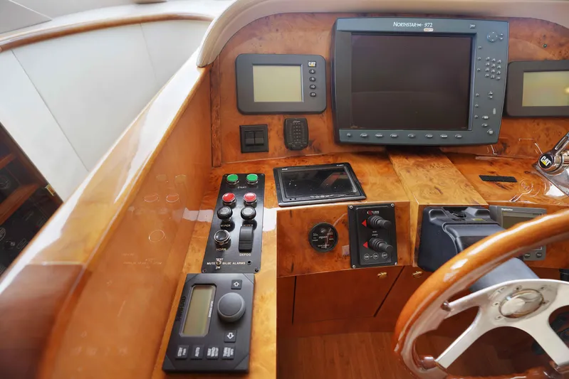 Carrie Ann Yacht Photos Pics Control panel of a 2006 Neptunus 62 Flybridge yacht with navigation equipment.