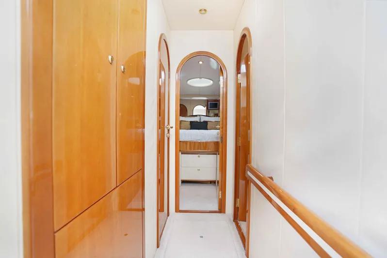 Carrie Ann Yacht Photos Pics Hallway inside 2006 Neptunus 62 Flybridge yacht with wooden doors and bright lighting.
