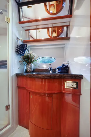 Carrie Ann Yacht Photos Pics Luxurious bathroom interior of 2006 Neptunus 62 Flybridge yacht with elegant wood cabinetry.
