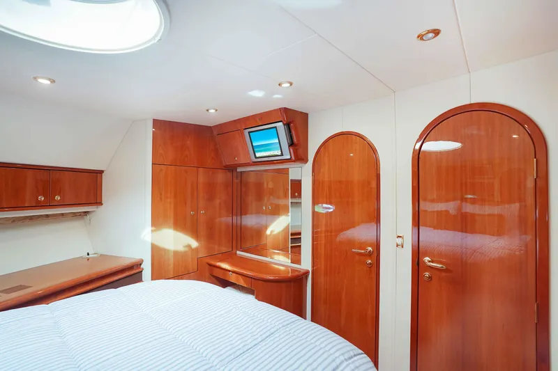 Carrie Ann Yacht Photos Pics Luxurious cabin interior of 2006 Neptunus 62 Flybridge yacht with wood finish and modern amenities.