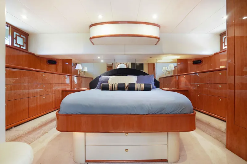 Carrie Ann Yacht Photos Pics Luxurious 2006 Neptunus 62 Flybridge yacht bedroom with elegant wood finish and modern design.