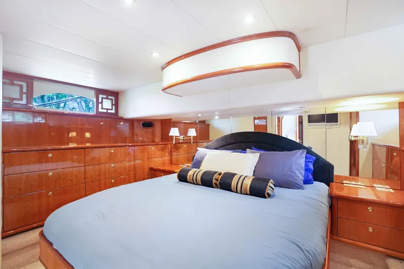 Carrie Ann Yacht Photos Pics Luxurious bedroom interior of 2006 Neptunus 62 Flybridge yacht with elegant wood finish.