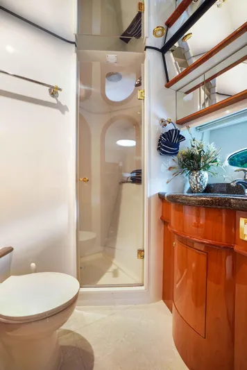 Carrie Ann Yacht Photos Pics Luxurious bathroom in 2006 Neptunus 62 Flybridge yacht with elegant wood cabinetry.