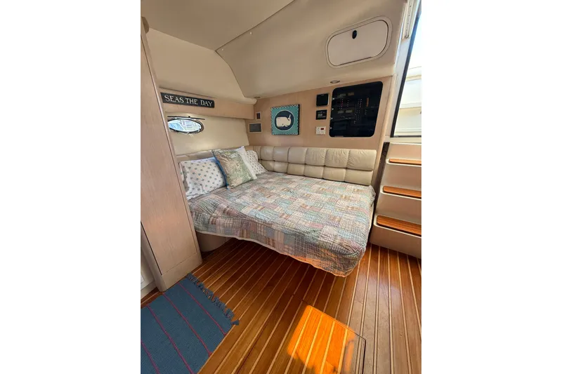 Big Time Yacht Photos Pics Cozy cabin interior of 1996 Tiara Yachts 3500 Express with bed and nautical decor.