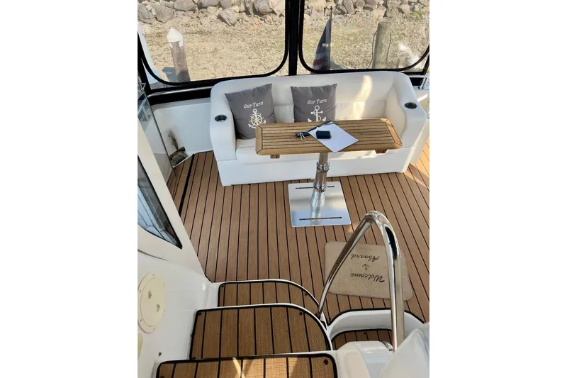 Our Turn Yacht Photos Pics 2001 Carver 396 Aft Cabin Motor Yacht interior with teak flooring and cushioned seating.