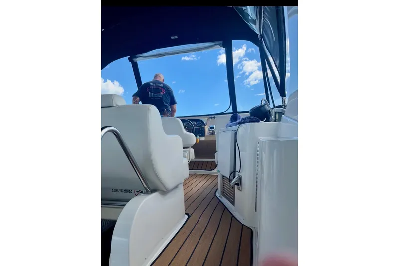 Our Turn Yacht Photos Pics 2001 Carver 396 Aft Cabin Motor Yacht interior with helm and seating area.