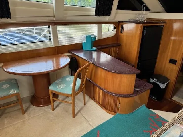 Wahooy Yacht Photos Pics Interior of 2001 Carver 396 Motoryacht with dining area and kitchenette.