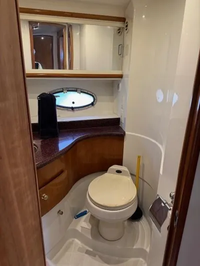 Wahooy Yacht Photos Pics Bathroom interior of 2001 Carver 396 Motoryacht with toilet, sink, and porthole window.