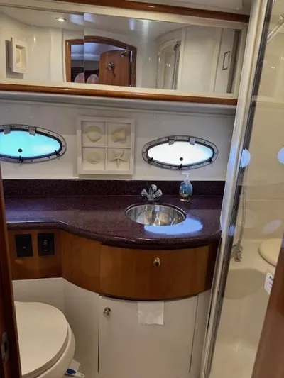 Wahooy Yacht Photos Pics Luxurious bathroom in 2001 Carver 396 Motoryacht with elegant fixtures and porthole windows.