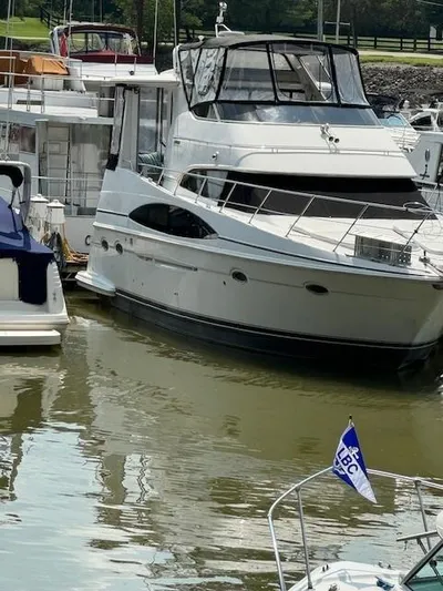 Wahooy Yacht Photos Pics 2001 Carver 396 Motoryacht docked in a marina, surrounded by other boats.