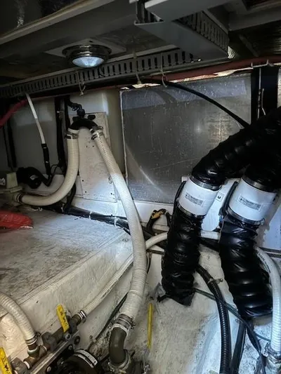 Wahooy Yacht Photos Pics Engine room of a 2001 Carver 396 Motoryacht with visible hoses and wiring.