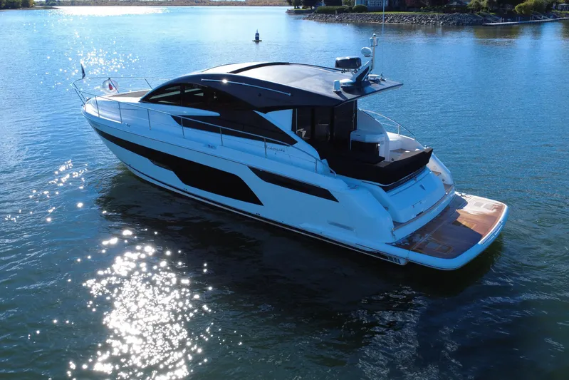  Yacht Photos Pics 2023 Fairline Targa 50 yacht on serene water, showcasing sleek design and luxury features.