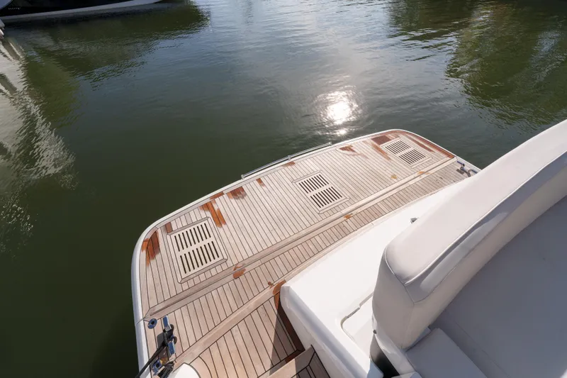  Yacht Photos Pics 2023 Fairline Targa 50 yacht with teak deck, reflecting sunlight on calm water.