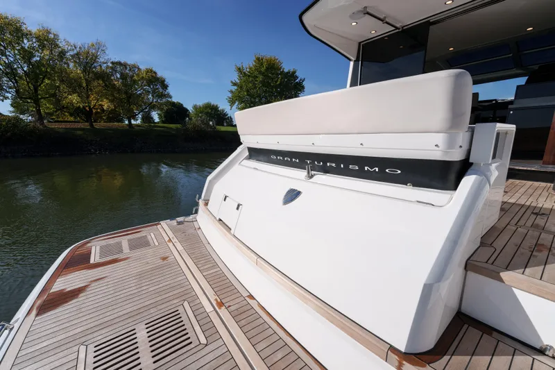  Yacht Photos Pics 2023 Fairline Targa 50 yacht with teak deck, docked by a serene river.