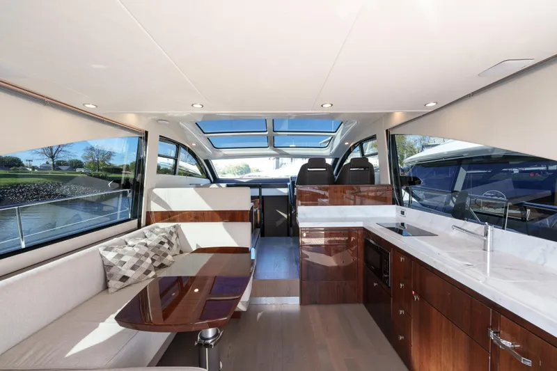  Yacht Photos Pics Luxurious interior of 2023 Fairline Targa 50 yacht with modern kitchen and seating area.